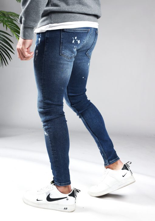 Achterkant denim heren jeans skinny fit met damaged look, broekzakken, knoopsluiting en riemlussen.