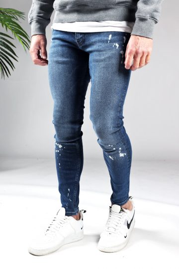 Linker zijaanzicht denim heren jeans skinny fit met damaged look, broekzakken, knoopsluiting en riemlussen.