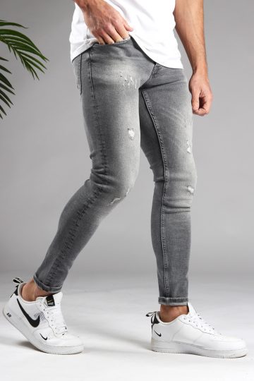Rechter zijkant lichtgrijze denim skinny jeans voor heren met damaged afwerking.