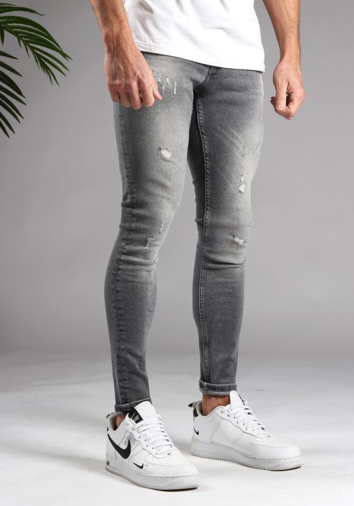 Rechter zijaanzicht lichtgrijze denim skinny jeans voor heren met damaged afwerking.