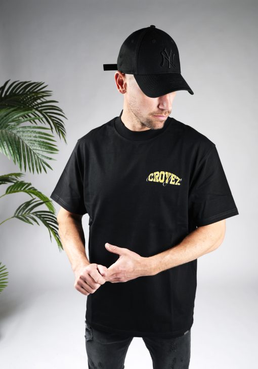 Vooraanzicht van heren T-shirt in zwarte kleur, met een ronde hals en een box fit pasvorm. Het T-shirt is voorzien van tekst op de linkerborst.