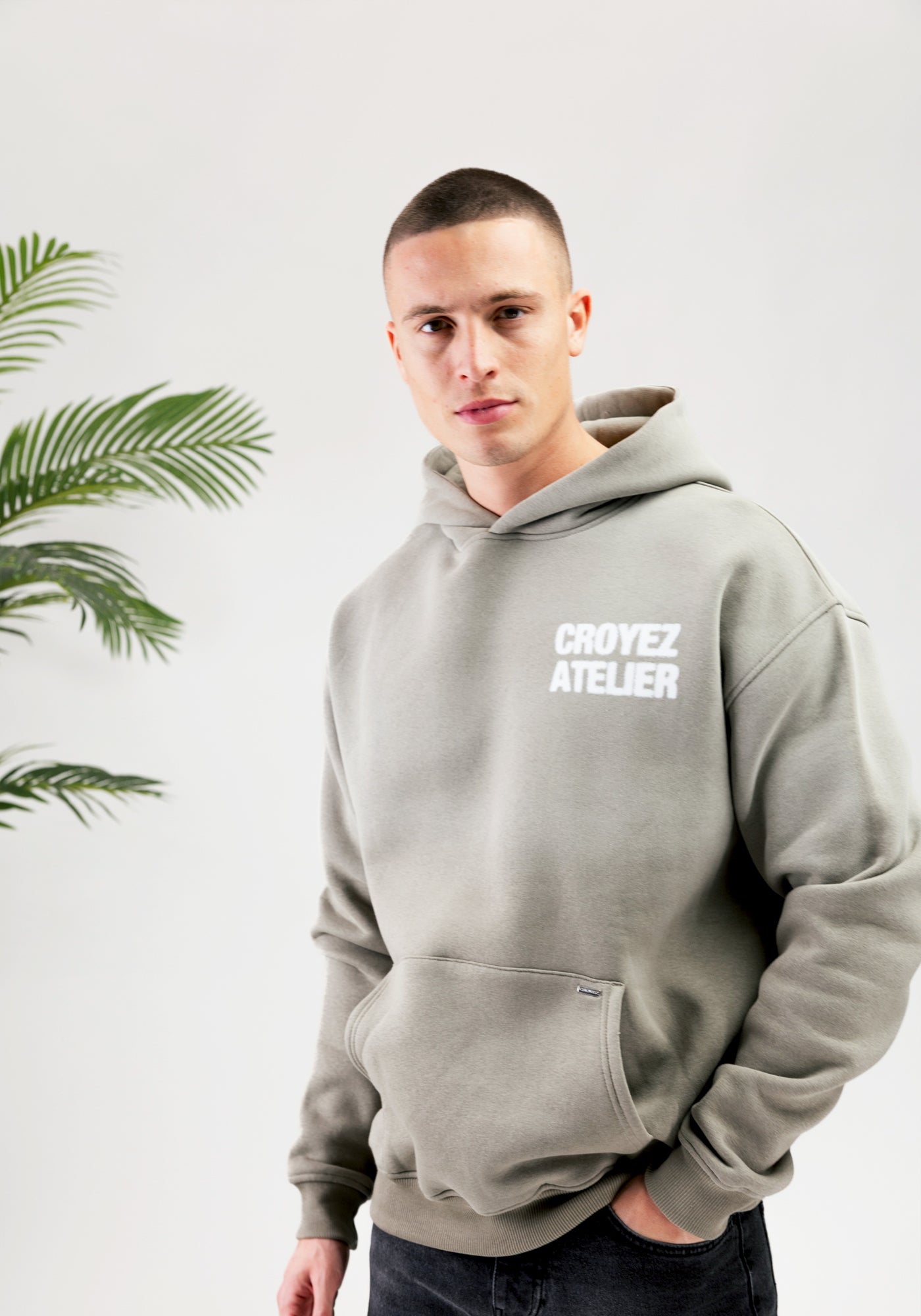 https://cdn.shopify.com/s/files/1/0935/6315/8909/files/CROYEZ_SPRAYED_ATELIER_HOODIE--CD1083-DUSTY_OLIVE-1.jpg?v=1771517401 Cotton District CROYEZ SPRAYED ATELIER HOODIE DUSTY OLIVE