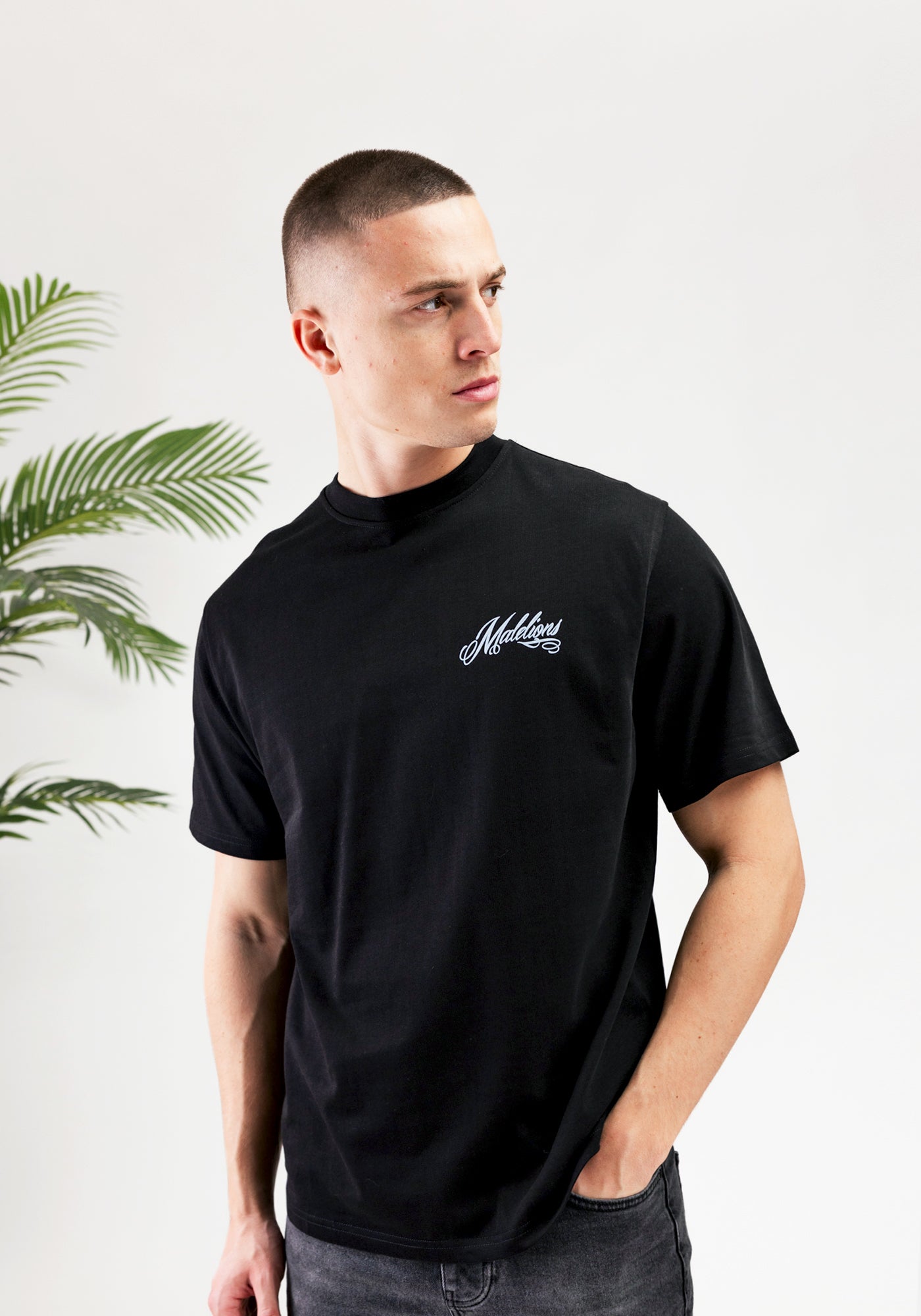https://cdn.shopify.com/s/files/1/0935/6315/8909/files/MALELIONS_PLAYING_CARD_T-SHIRT--CD1052-BLACK-1.jpg?v=1771498002 Cotton District MALELIONS PLAYING CARD T-SHIRT BLACK