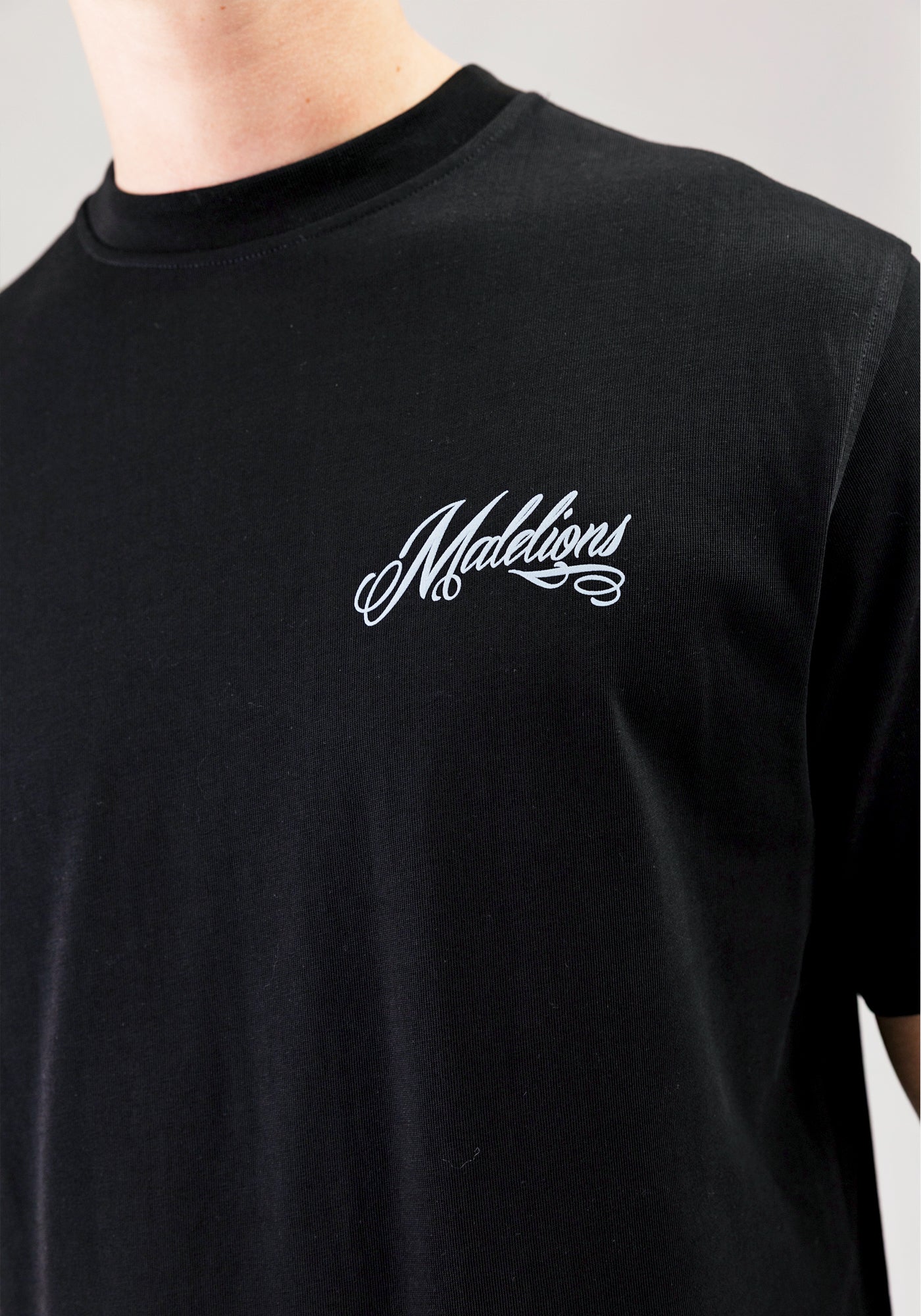 https://cdn.shopify.com/s/files/1/0935/6315/8909/files/MALELIONS_PLAYING_CARD_T-SHIRT--CD1052-BLACK-2.jpg?v=1771498002 Cotton District MALELIONS PLAYING CARD T-SHIRT BLACK