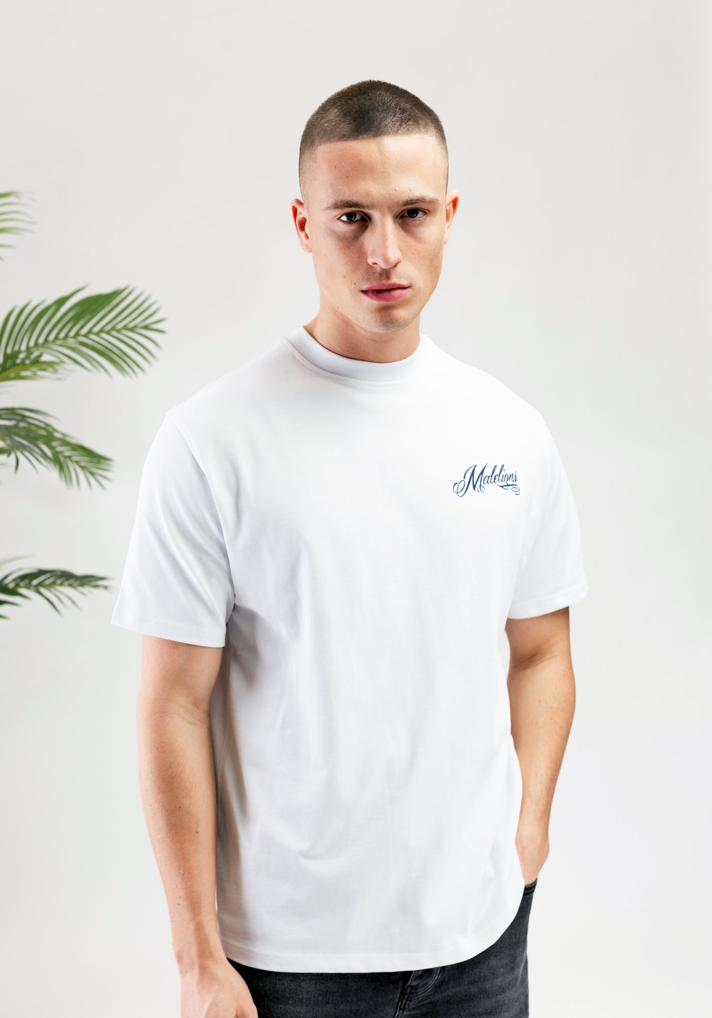 https://cdn.shopify.com/s/files/1/0935/6315/8909/files/MALELIONS_PLAYING_CARD_T-SHIRT--CD1052-WHITE-2.jpg?v=1771498023 Cotton District MALELIONS PLAYING CARD T-SHIRT WHITE